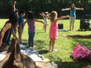 Camas: A group of kids enjoying a sunny afternoon during one of the Camas Public Library’s Storytime in Camas Parks events this summer.