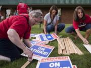 Alisha Jucevic/The Columbian Kristen Molina, left, Anna Stepan, center and JoAnn Delyea, teachers at Illahee Elementary School make signs after the Evergreen Education Association general membership meeting at Evergreen High School in Vancouver on Thursday. As of press time, 96.88 percent of the union's membership had voted in favor of striking.