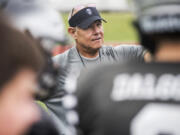 Mark Rego, Union High School assistant football coach, listens to a player during a drill at a Union practice on Thursday afternoon, Aug. 23, 2018.