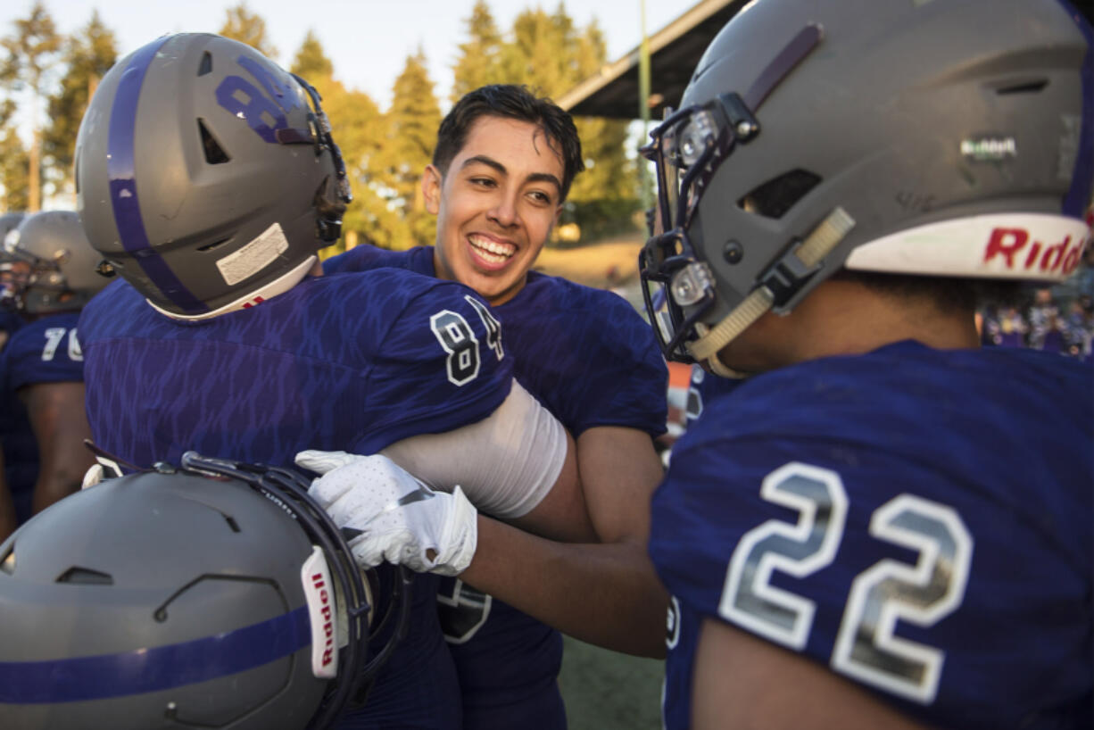 Heritage's Orlando Patino-Gonzalez (15) celebrates with his team after catching a game-winning interception at McKenzie Stadium on Friday night, Aug. 31, 2018.