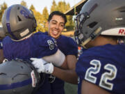 Heritage's Orlando Patino-Gonzalez (15) celebrates with his team after catching a game-winning interception at McKenzie Stadium on Friday night, Aug. 31, 2018.