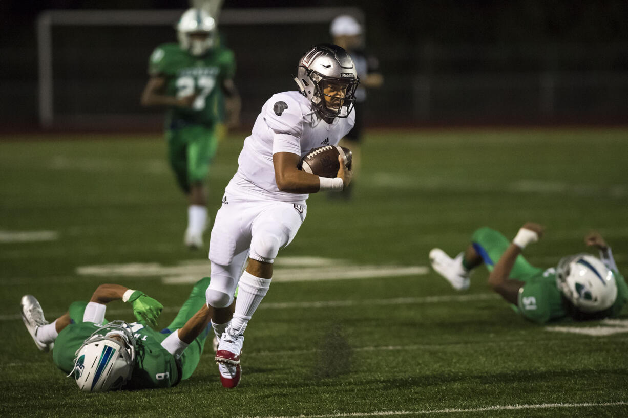 Union's Lincoln Victor (5) breaks a tackle from a Mountain View defender in the first quarter at McKenzie Stadium on Friday night, Aug. 31, 2018.