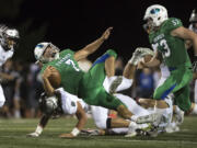 Mountain View's Jack Mertens (7) is taken down by Union defenders in the third quarter at McKenzie Stadium on Friday night, Aug. 31, 2018.