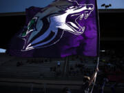 A Heritage cheerleader runs the flag up feild following a Heritage touchdown in the first quarter against Evergreen at McKenzie Stadium on Friday night, Aug. 31, 2018.