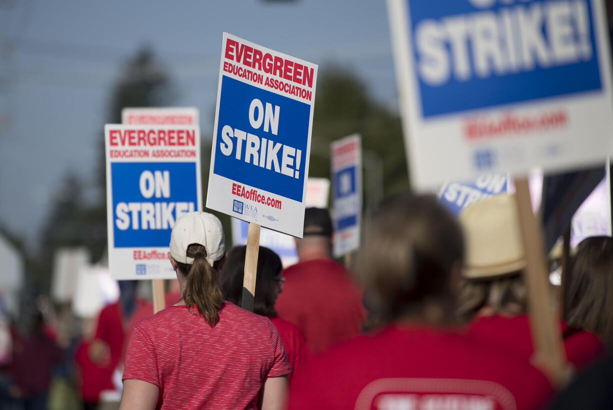 Members of the Evergreen Education Association take to the picket line outside Burton Elementary School on Tuesday morning, Aug. 28, 2018.