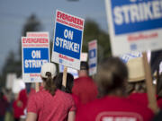 Members of the Evergreen Education Association take to the picket line outside Burton Elementary School on Tuesday morning, Aug. 28, 2018.