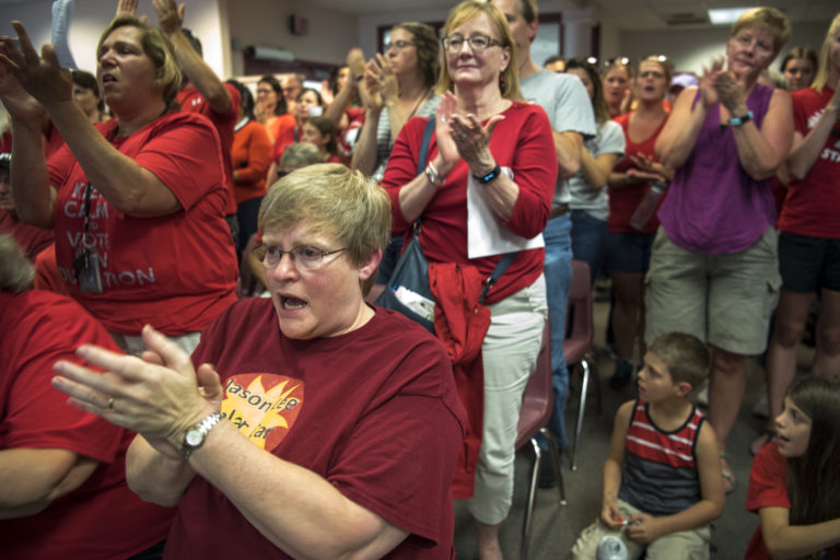 Susan VanHouten, teacher at Jason Lee Middle School and member of the Vancouver Education Association bargaining team, applauds as board member Wendy Smith opposes a resolution during the Vancouver Public Schools board meeting in Vancouver on Tuesday.