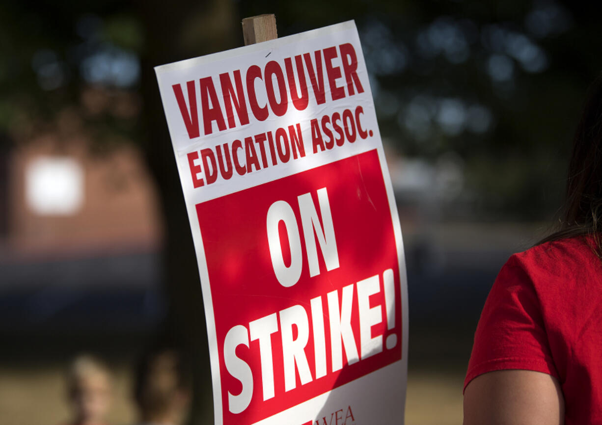 Hudson’s Bay High School teachers greet traffic outside the school while on strike Wednesday morning.