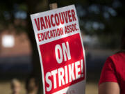 Hudson’s Bay High School teachers greet traffic outside the school while on strike Wednesday morning.