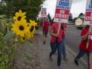 Teachers and supporters march through the neighborhood surrounding Captain Strong Primary School while picketing in Battle Ground on Thursday morning, Aug. 30, 2018.