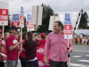 Summit View High School teacher Stewart Demos, right, chats with fellow educators as they greet motorists along Lewisville Highway while on strike Thursday morning. Demos has been a teacher for 20 years, and said he’s frustrated by the ongoing negotiations. “It’s just shady,” he said.