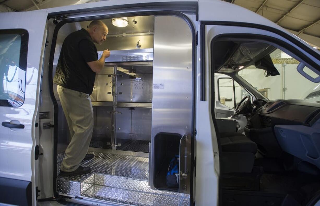 Bob Bergquist, Clark County interim animal protection and control manager, looks over the interior of a new animal protection van at the Public Works Operations Center.