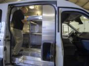 Bob Bergquist, Clark County interim animal protection and control manager, looks over the interior of a new animal protection van at the Public Works Operations Center.