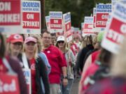 Hockinson teachers and supporters march with signs outside Hockinson Middle School on Friday morning, Aug. 31, 2018.