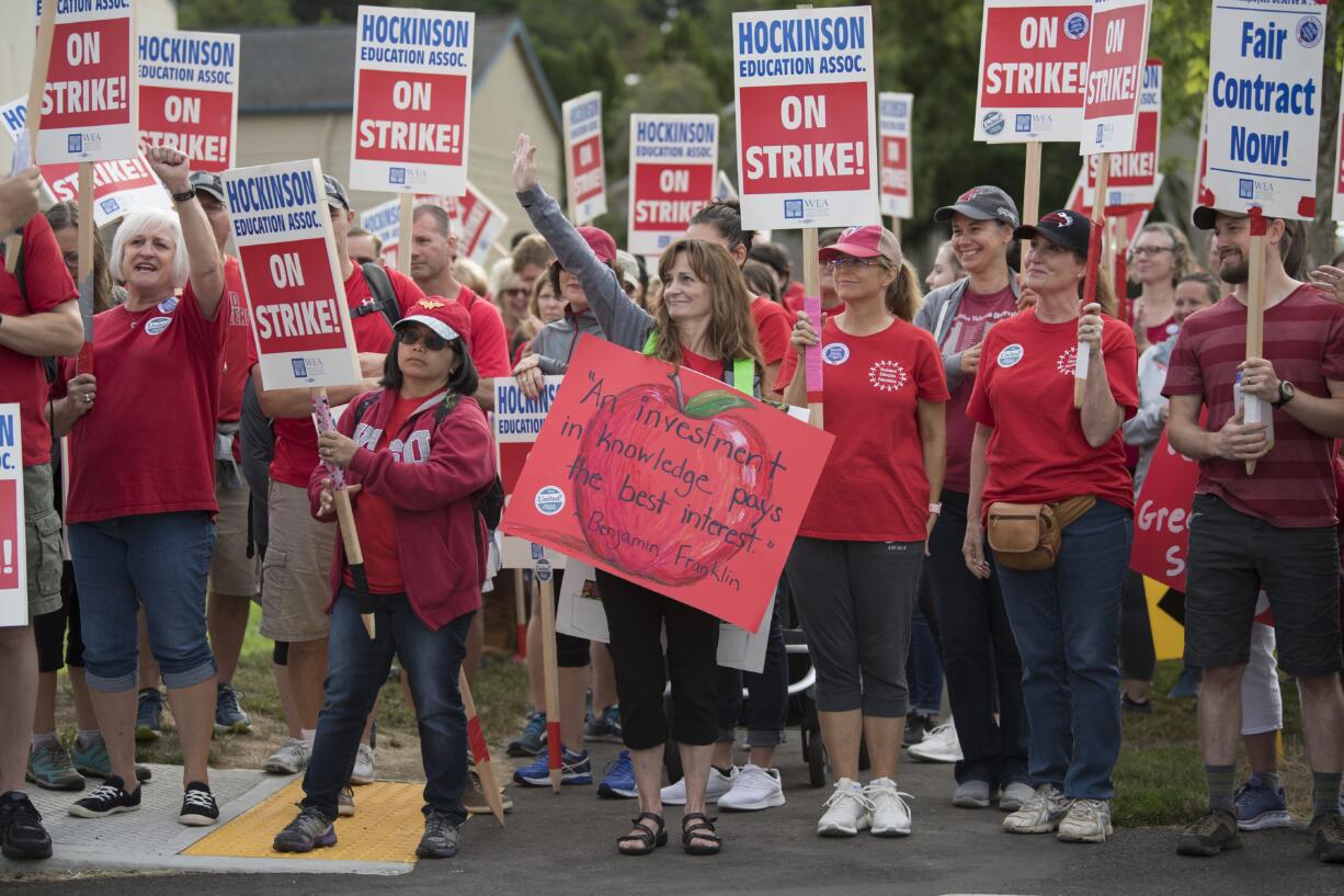 Hockinson teachers and supporters rally with signs outside Hockinson Middle School as they talk about their future Friday morning, Aug. 31, 2018.