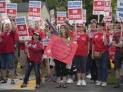 Hockinson teachers and supporters rally with signs outside Hockinson Middle School as they talk about their future Friday morning, Aug. 31, 2018.