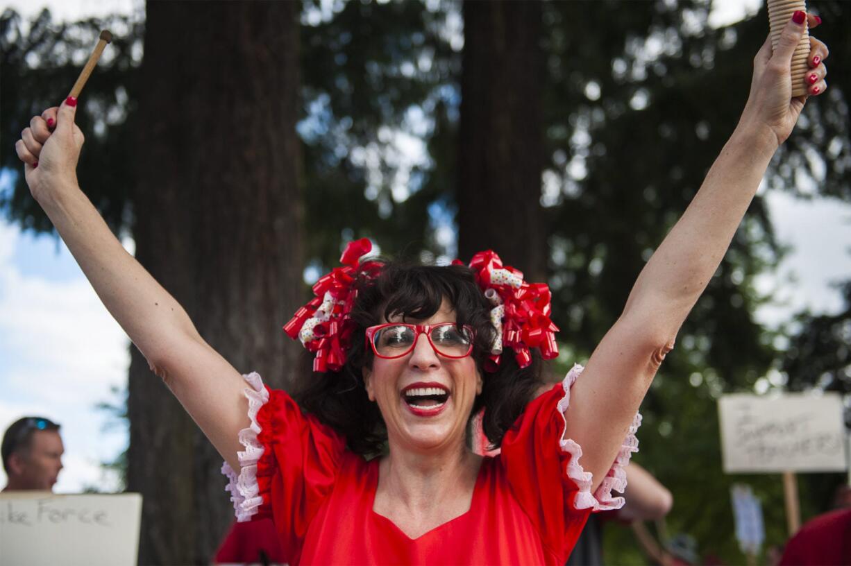 Marta Gray, 7th grader teacher at Thomas Jefferson Middle School leads a cheer while teachers rally in front of the Vancouver Public Schools' Administration Building on Friday afternoon, Aug. 31, 2018.