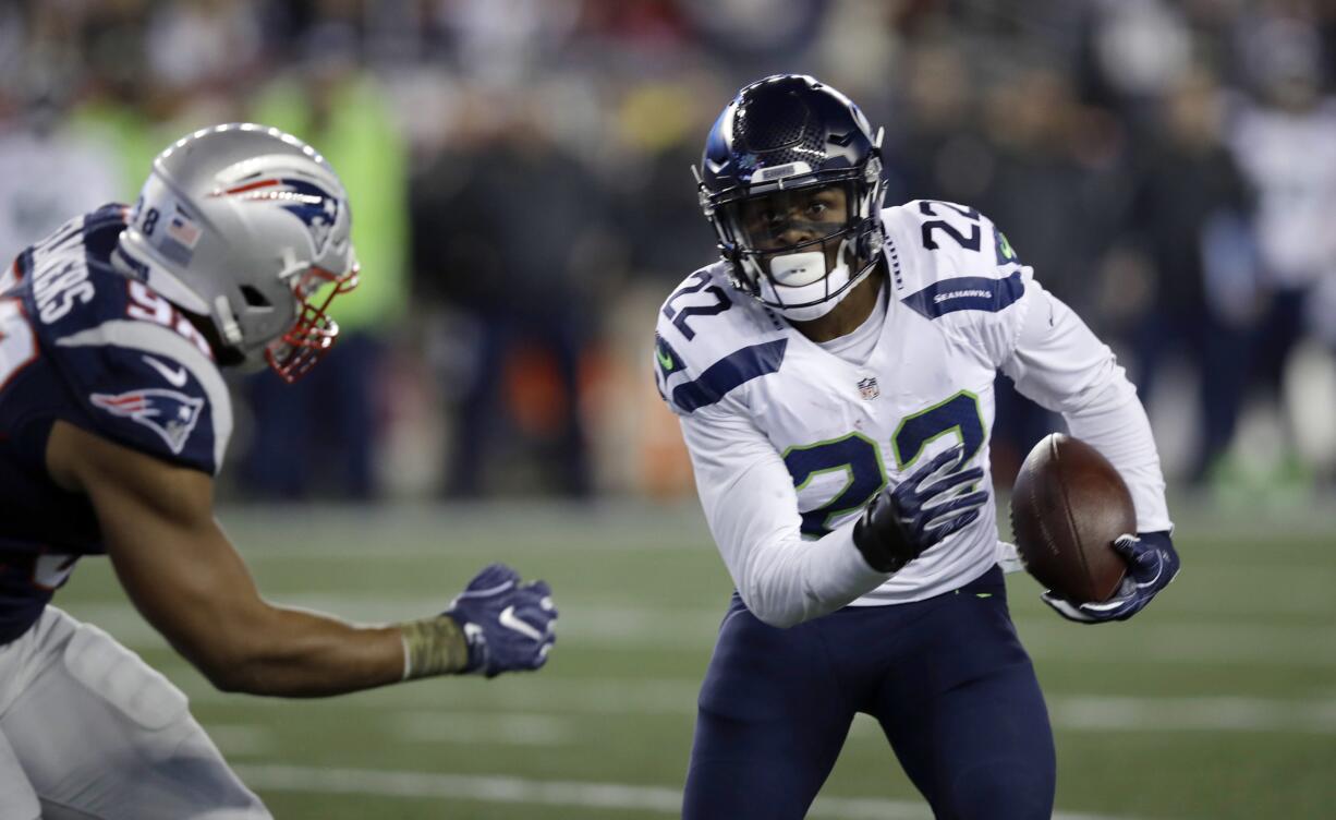 New England Patriots defensive lineman Trey Flowers (98) chases Seattle Seahawks running back C.J. Prosise (22) during the first half of an NFL football game, Sunday, Nov. 13, 2016, in Foxborough, Mass.