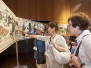 Japanese visitors examine the 108-foot-long Fort Vancouver Tapestry during a recent exhibition. The tapestry is displayed on special occasions — like this week’s Vancouver Chautauqua.