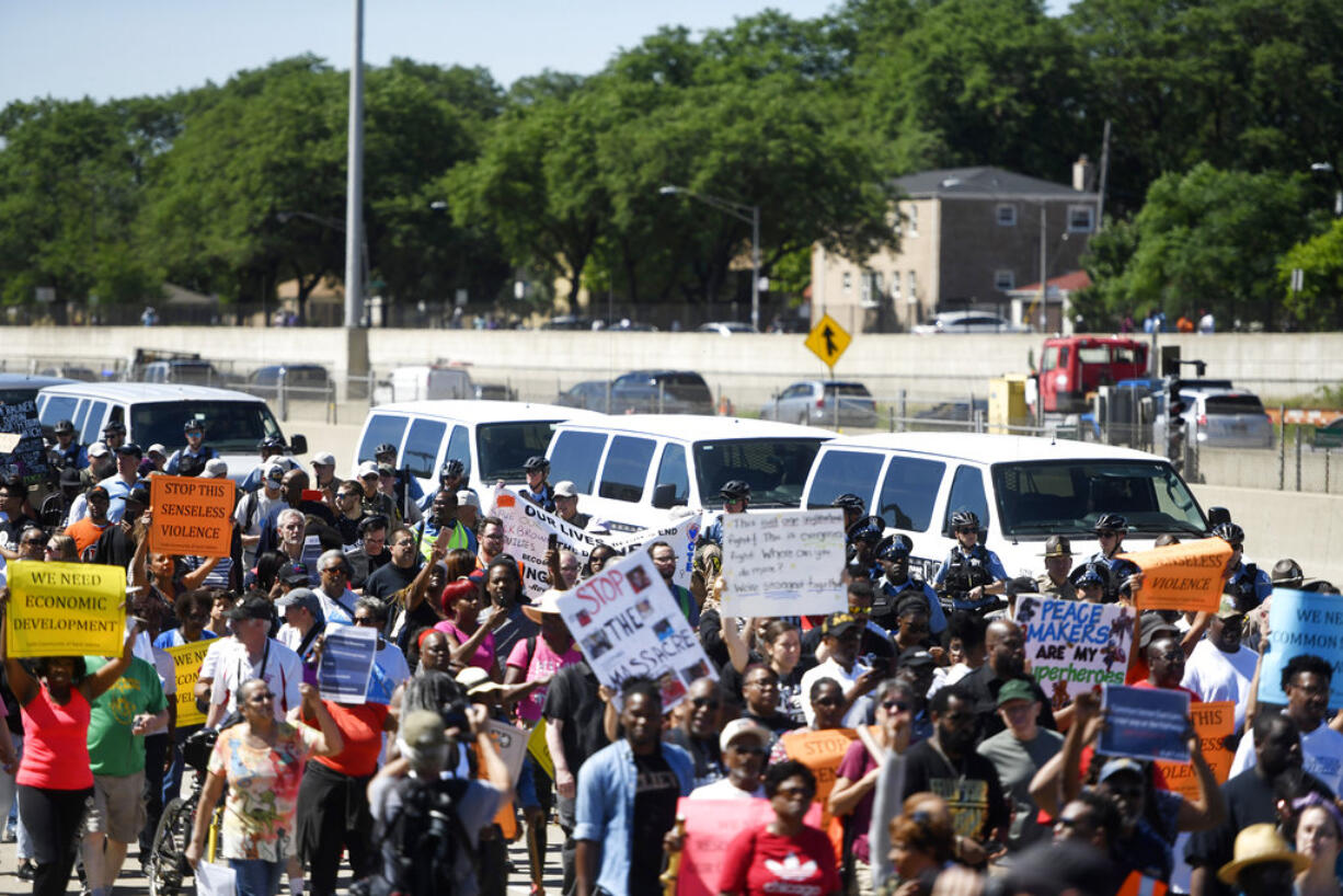 FILE - In this July 7, 2018, photo, protesters march on the Dan Ryan Expressway in Chicago. The protesters shut down the expressway in an attempt to increase pressure on public officials to address the gun violence that's claimed hundreds of lives in some of the city's poorest neighborhoods. Chicago officials have issued parking bans and are warning motorists of rolling street closures ahead of a rush-hour protest march along the city's always busy Lake Shore Drive. Protesters plan to gather on the thoroughfare Thursday afternoon, Aug. 2 and march north toward Wrigley Field.