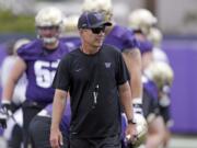 Washington head coach Chris Petersen walks on the field during a team football practice Friday, Aug. 3, 2018, in Seattle.