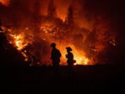 Firefighters monitor a backfire while battling the Ranch Fire, part of the Mendocino Complex Fire, on Tuesday, Aug. 7, 2018, near Ladoga, Calif.