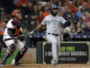 Seattle Mariners' Denard Span watches his two-run home run in front of Houston Astros catcher Martin Maldonado during the second inning of a baseball game Thursday, Aug. 9, 2018, in Houston. (AP Photo/David J.