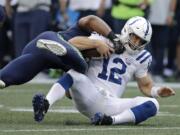 Indianapolis Colts quarterback Andrew Luck (12) is tackled by Seattle Seahawks linebacker Bobby Wagner during the first half of an NFL football preseason game, Thursday, Aug. 9, 2018, in Seattle.