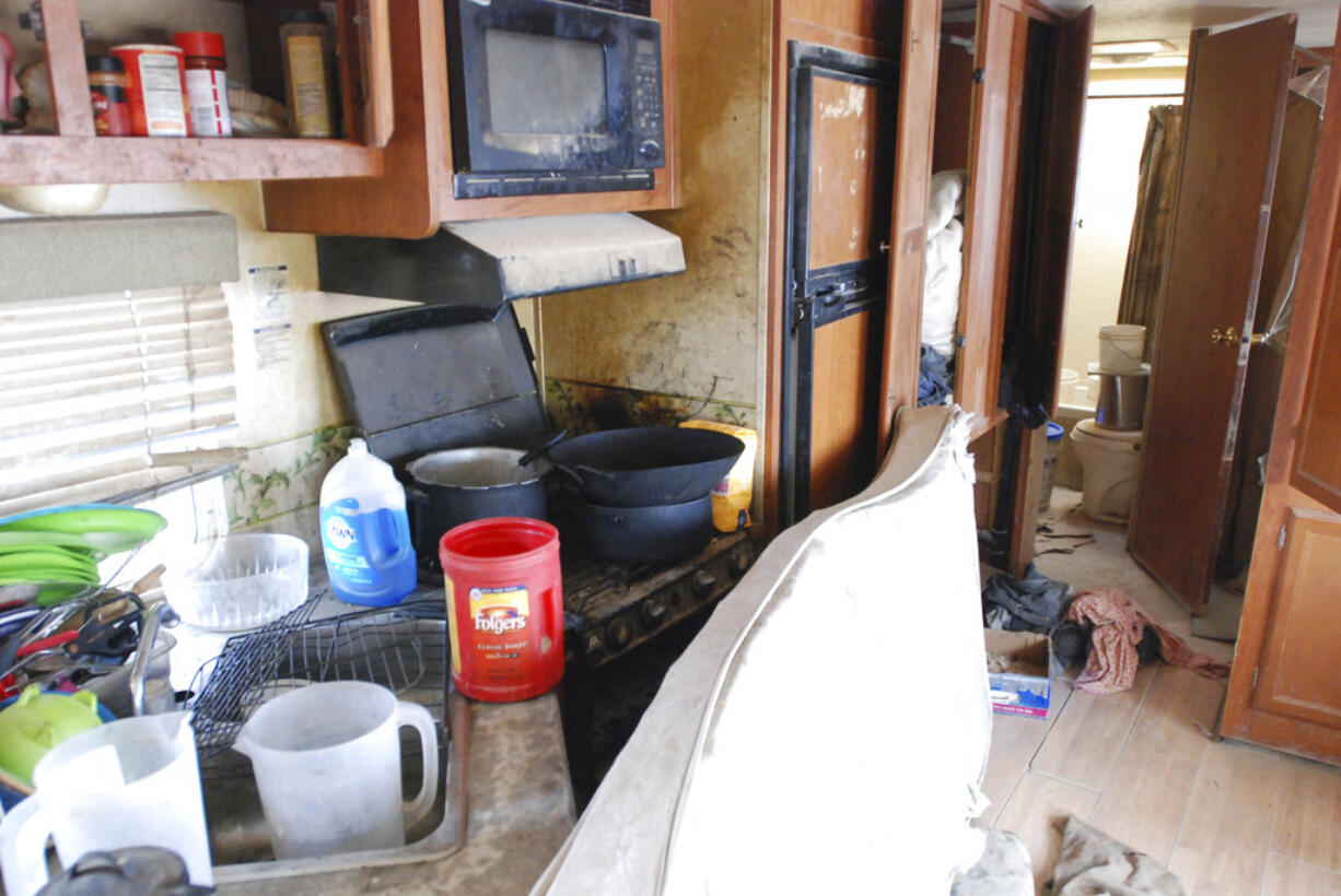 Various items litter the kitchen of a makeshift living compound in Amalia, N.M., on Friday, Aug. 10, 2018, where five adults were arrested on child abuse charges and remains of a boy were found. The remains, which haven't been positively identified, may resolve the fate of Abdul-ghani Wahhaj, a missing, severely disabled Georgia boy. Eleven other children were found at the compound during a raid last week.