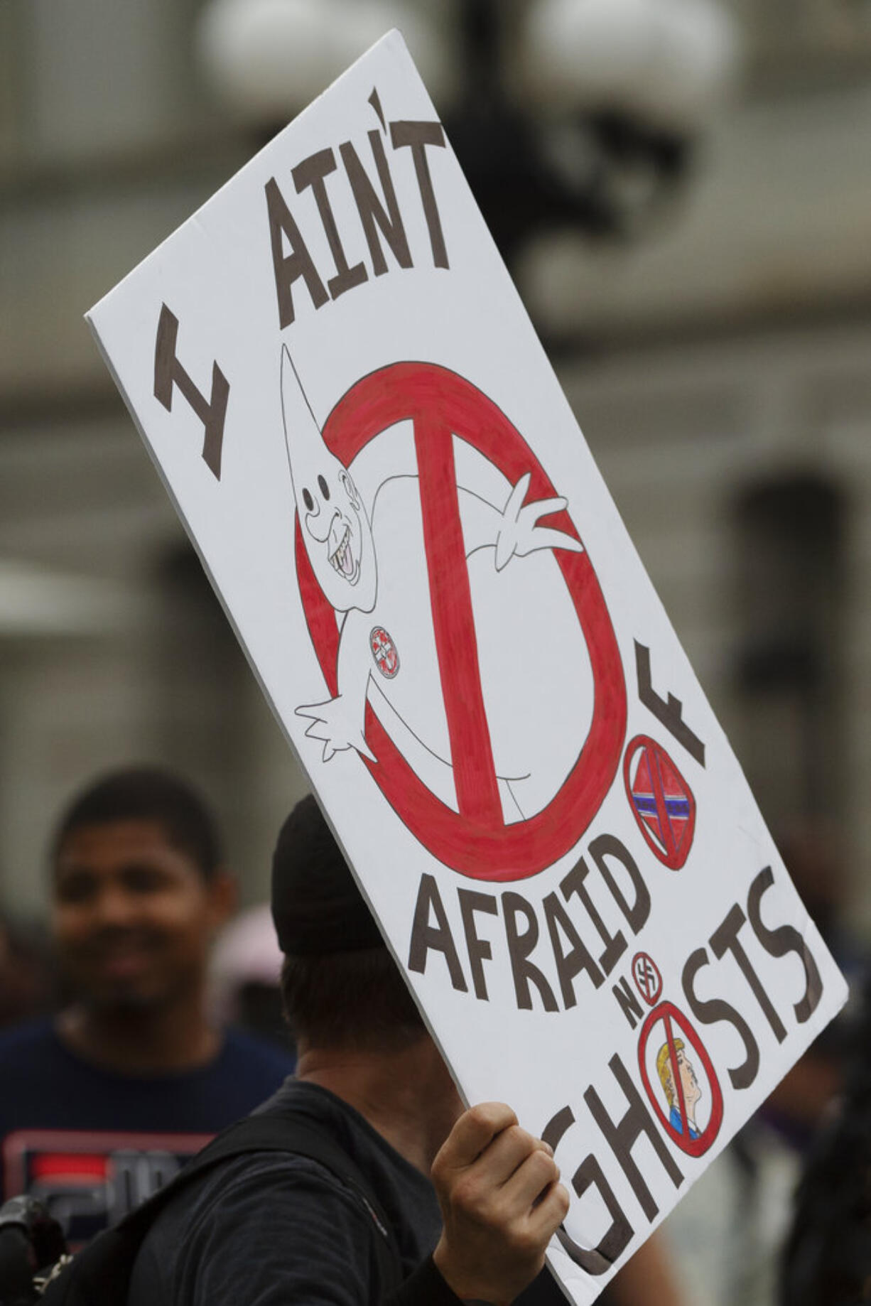 Counter-protesters gather on 17th street outside of the White House security barrier on Pennsylvania Avenue during the "Unite the Right 2" rally in Washington, Sunday, Aug. 12, 2018.