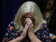 Judy Deaven who says her son was a victim of sexual abuse by a priest as a boy reacts as Pennsylvania Attorney General Josh Shapiro speaks during a news conference at the Pennsylvania Capitol in Harrisburg, Pa., Tuesday, Aug. 14, 2018. A Pennsylvania grand jury says its investigation of clergy sexual abuse identified more than 1,000 child victims. The grand jury report released Tuesday says that number comes from records in six Roman Catholic dioceses.