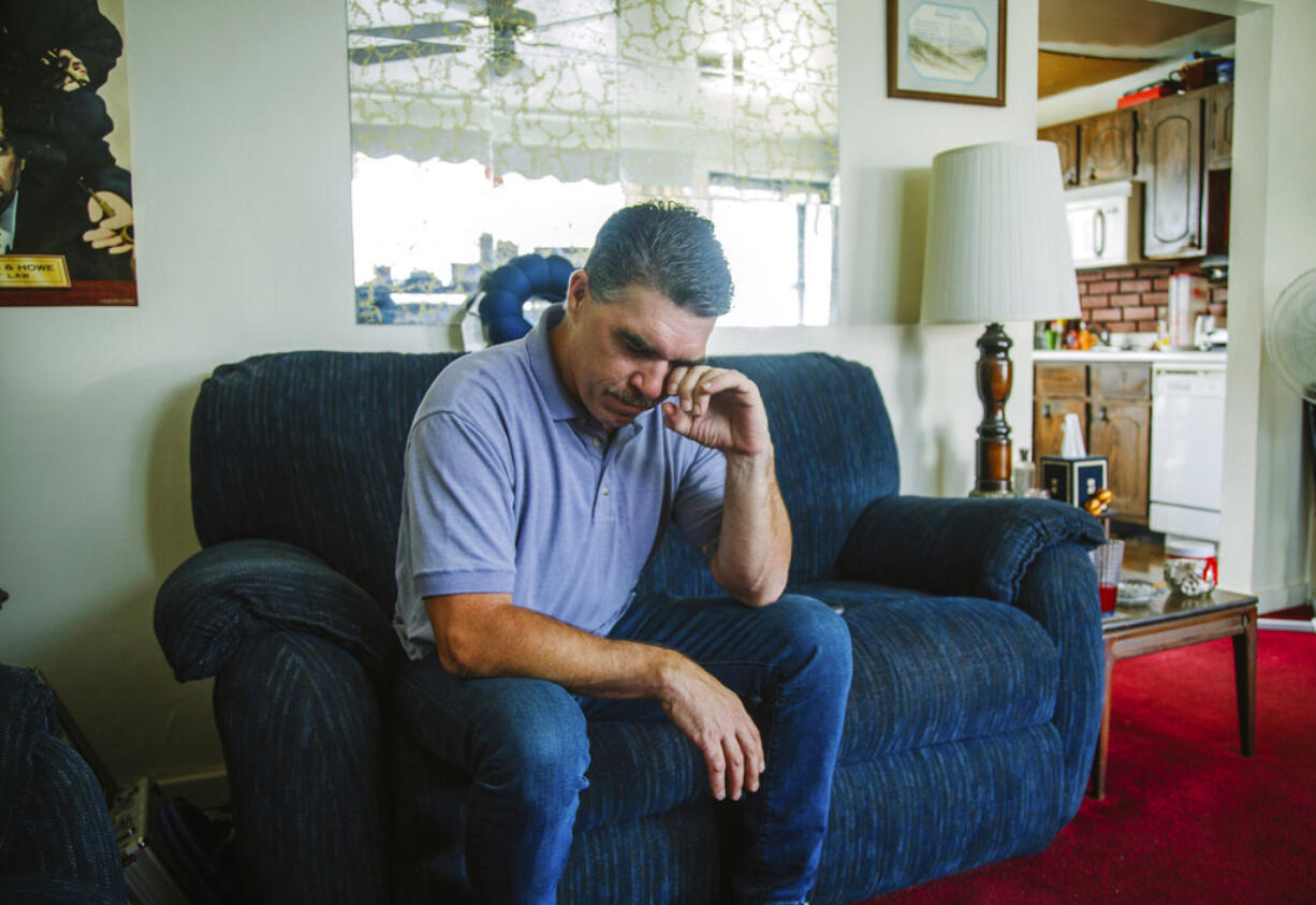 Robert Mizic, 47, watches a press conference on the grand jury report investigating sexual abuse within the Catholic Church in Pennsylvania at his home on Tuesday, Aug. 14, 2018, in Turtle Creek, Pa. Mizic says he was abused by his parish priest at a Catholic Church in suburban Philadelphia 35 years ago.