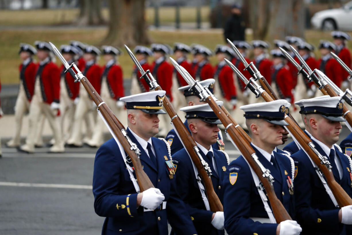 FILE - In this Jan. 20, 2017 file photo, military units march in the inaugural parade from the U.S. Capitol, Friday, Jan. 20, 2017, in Washington. Trump’s lofty vision of big tanks and vintage aircraft moving through the streets of Washington in a show of patriotic force crumbled Friday under the weight of logistics, including a $92 million price tag.