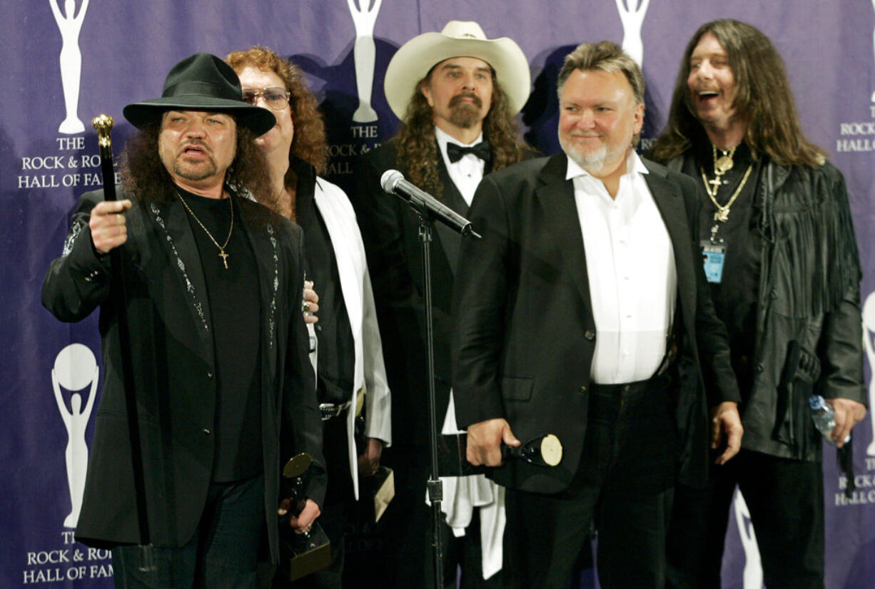 FILE - In this March 13, 2006 file photo, members of Lynyrd Skynyrd, from left, Gary Rossington, Billy Powell, Artimus Pyle, Ed King and Bob Burns, appear backstage after being inducted at the annual Rock and Roll Hall of Fame dinner in New York.  A family statement said King, who helped write several of their hits including “Sweet Home Alabama,” died from cancer, Wednesday, Aug. 22, 2018, in Nashville, Tenn. He was 68.