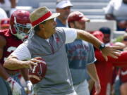 Alabama head coach Nick Saban throws a pass during a NCAA college football practice, Saturday, Aug. 4, 2018, in Tuscaloosa, Ala.