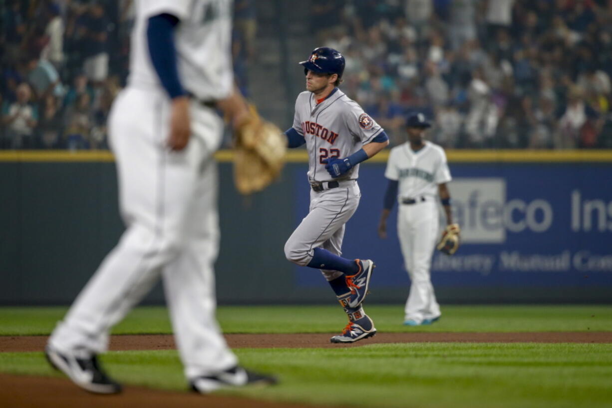 Houston Astros’ Josh Reddick trots around the bases after hitting a solo home run off of Seattle Mariners pitcher Ross Detwiler during the fourth inning of a baseball game Tuesday, Aug. 21, 2018, in Seattle.