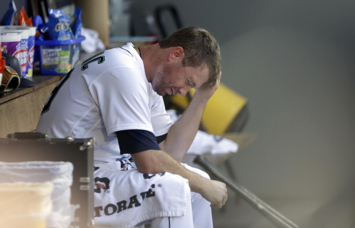 Seattle Mariners starting pitcher Wade LeBlanc sits in the dugout after being relieved in the fifth inning of a baseball game against the Houston Astros, Wednesday, Aug. 1, 2018, in Seattle.