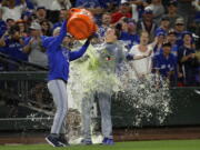 Toronto Blue Jays winning pitcher Ryan Borucki, right, is doused after the Blue Jays defeated the Seattle Mariners 7-2 in a baseball game Friday, Aug. 3, 2018, in Seattle. (AP Photo/Ted S.