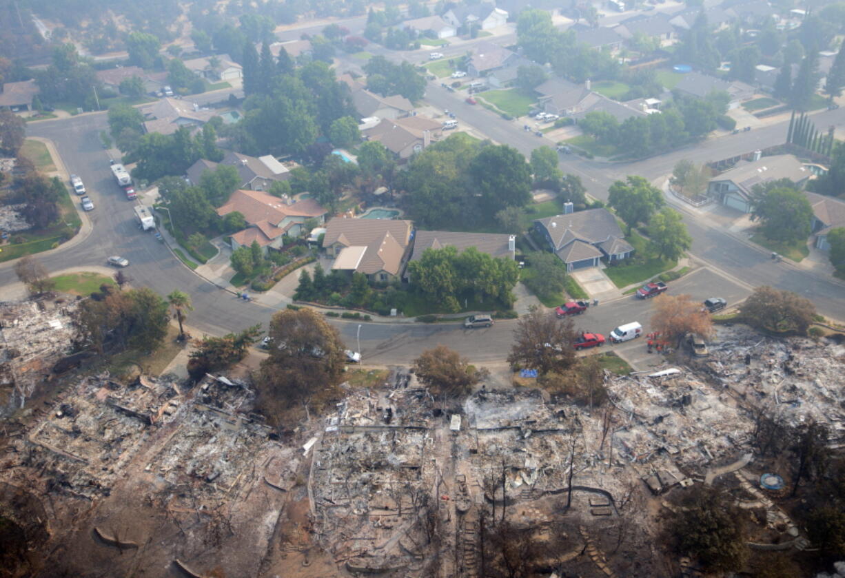 Homes destroyed by a wildfire are seen from an aerial view in the Keswick neighborhood of Redding, Calif., Friday, Aug. 10, 2018. Fire crews have made progress against the biggest blaze in California history but officials say the fire won't be fully contained until September.