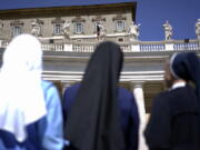 Nuns look up at Pope Francis delivering his blessing during the Regina Coeli prayer he celebrated from the window of his studio overlooking St. Peter’s Square, at the Vatican. Advocates of women’s ordination as Roman Catholic priests are citing the church’s unfolding sex abuse scandals in mid-2018 as powerful arguments for their cause, while acknowledging, as they do so, the high unlikelihood of achieving their goal any time soon.