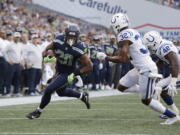 Seattle Seahawks running back Rashaad Penny (20) rushes past Indianapolis Colts defensive back T.J. Green (32) during the first half of an NFL football preseason game, Thursday, Aug. 9, 2018, in Seattle.