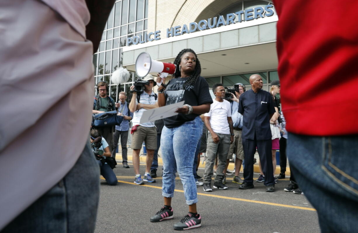 Cori Bush speaks on a bullhorn to protesters outside the St. Louis Police Department headquarters in St. Louis. Few members of Congress are more entrenched than William Lacy Clay of St. Louis, but Bush, a once-homeless woman spurred to activism in Ferguson believes she could be the next Democrat to pull off a big primary upset. Bush watched in June as Alexandria Ocasio-Cortez shocked the political establishment by beating 10-term Rep. Joseph Crowley in the New York Democratic primary. Bush is optimistic heading into Missouri’s Aug. 7 primary.