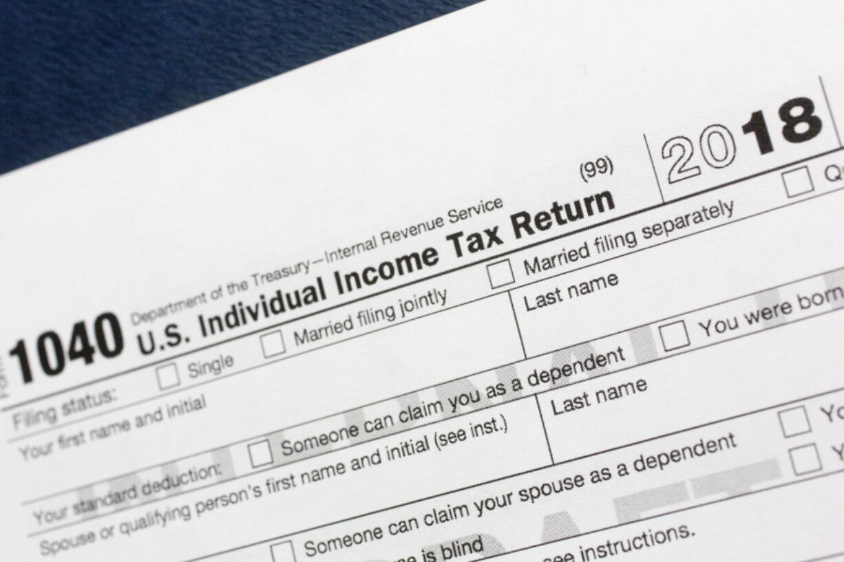 A portion of the 1040 U.S. Individual Income Tax Return form for 2018 is displayed, Tuesday, July 24, 2018, in New York. The $1.5-trillion tax overhaul includes the end of a 75-year-old deduction on alimony payments.