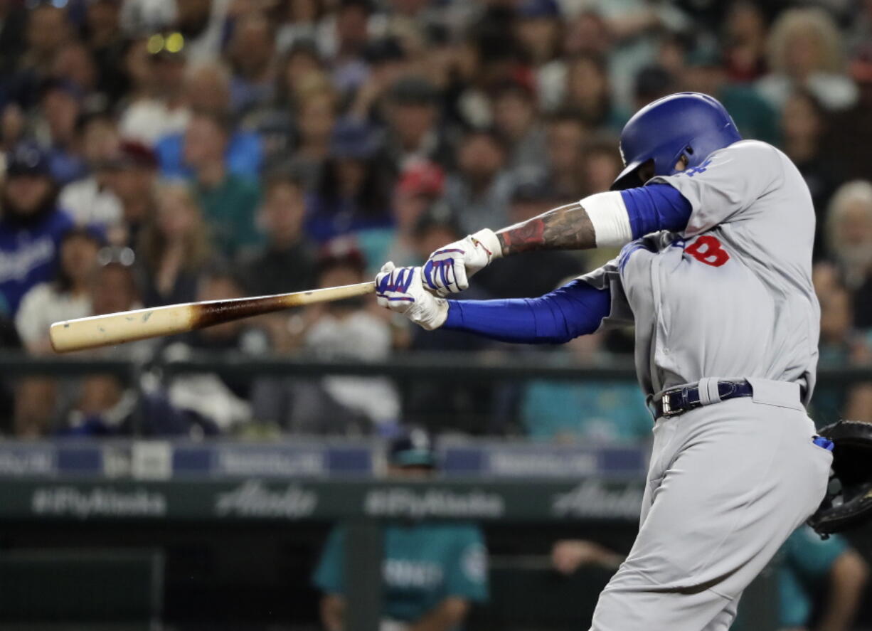 Los Angeles Dodgers’ Manny Machado hits a two-run home run during the seventh inning of the team’s baseball game against the Seattle Mariners, Friday, Aug. 17, 2018, in Seattle. It was Machado’s second home run of the game. (AP Photo/Ted S.