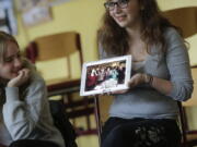 Jewish teenager Sophie Steiert, right, shows a picture of Jewish daily life on a tablet computer June 25 as Laura Schulmann looks on during a lesson as part of a project of religions at the Bohnstedt-Gymnasium high school in Luckau, Germany.