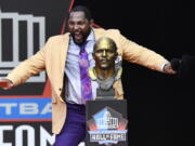 Former Baltimore Ravens linebacker Ray Lewis dances beside his bust as he delivers his induction speech at the Pro Football Hall of Fame Saturday, Aug. 4, 2018, in Canton, Ohio.