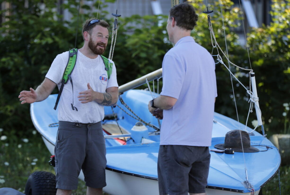 In this Thursday, Aug. 2, 2018 photo, State Rep. Owen Casas, I-Rockport, talks issues with Charlie Strout while campaigning in Camden, Maine. A national group that supports independent political candidates is pouring money into legislative races, raising alarm by critics who say so-called dark money is no longer limited to major political parties. (AP Photo/Robert F.