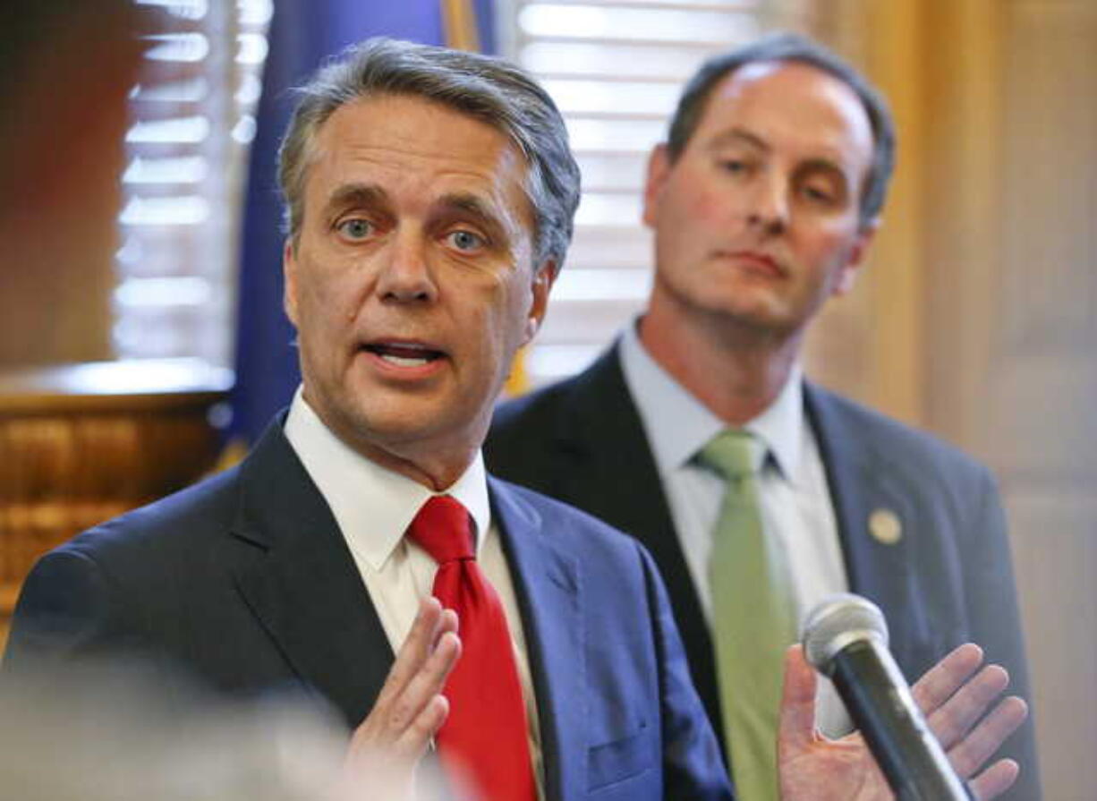 In this Aug. 8, 2018, file photo, Kansas Gov. Jeff Colyer, left, alongside Lt. Gov. Tracey Mann, addresses the media at the Kansas Statehouse in Topeka, Kan., a day after his primary race against Kansas Secretary of State Kris Kobach. Colyer conceded late Tuesday, Aug. 14, 2018, in the state's Republican gubernatorial primary, saying he will endorse Kobach a week after their neck-and-neck finish threatened to send the race to a recount.