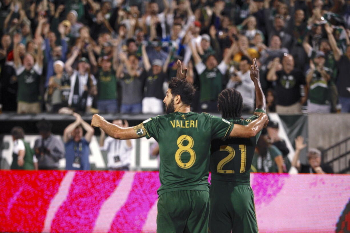 Portland Timbers' Diego Valeri (8) and Diego Chara (21) celebrate after Chara's second-half goal against Toronto FC during an MLS soccer match Wednesday, Aug. 29, 2018, in Portland, Ore.