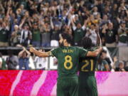 Portland Timbers' Diego Valeri (8) and Diego Chara (21) celebrate after Chara's second-half goal against Toronto FC during an MLS soccer match Wednesday, Aug. 29, 2018, in Portland, Ore.